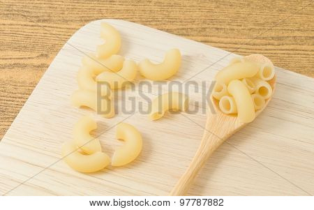 Elbow Macaroni Or Gomiti Pasta In A Wooden Spoon