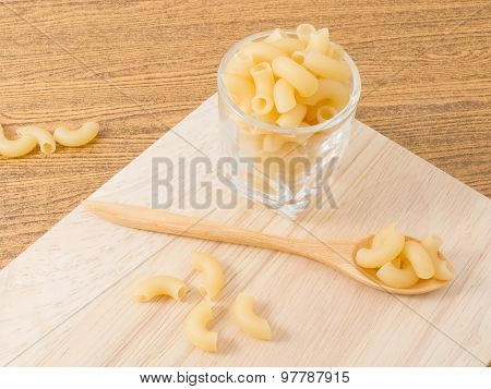 Elbow Macaroni Or Gomiti Pasta On Cutting Board