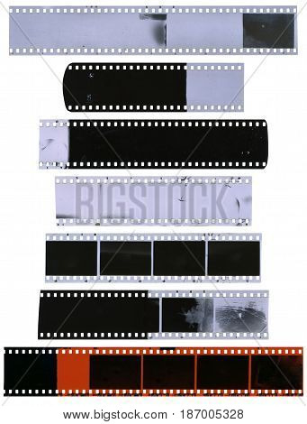 Old used dusty and scratched celluloid film strips isolated on white background