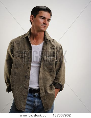The handsome cute guy looks off to his side.