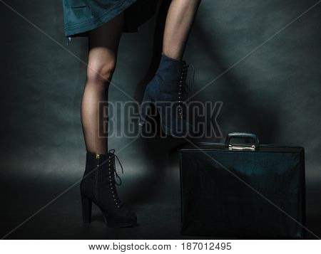 Journey and travel. Retro stylished girl with vintage big bag suitcase valise. Stylish victorian woman on dark background.