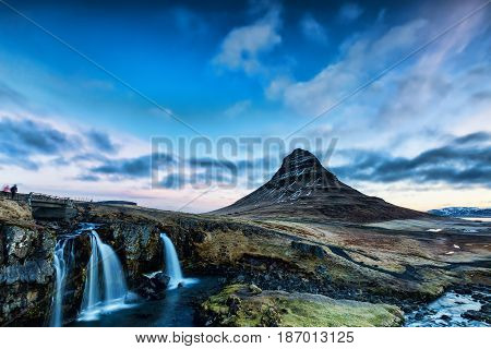 Spring Sunrise Over The Famous Kirkjufellsfoss Waterfall With Kirkjufell Mountain In The Background