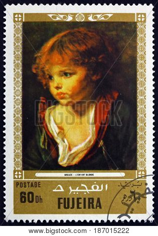 FUJEIRA - CIRCA 1972: a stamp printed in the Fujeira shows a Blond Haired Boy with an Open Shirt Painting by Jean Baptiste Greuze French Painter circa 1972