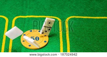Accessories for board games on a bright green background is a field for playing poker