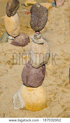 Stacked rocks on seashore in the sand