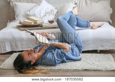 Girl Reading A Book In A Cozy Room
