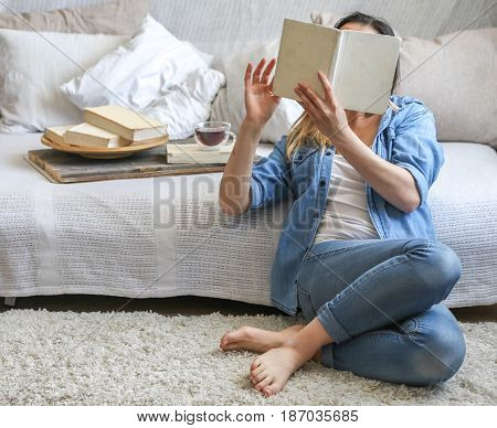 Girl Reading A Book In A Cozy Room