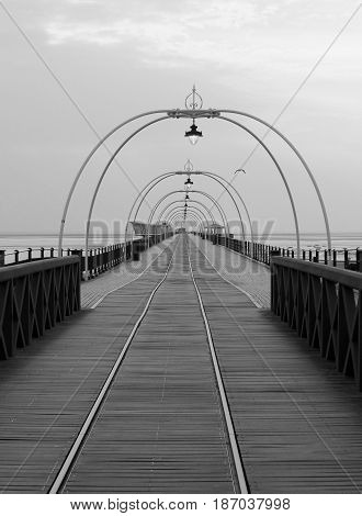southport pier at sunset with walkway and tram lines