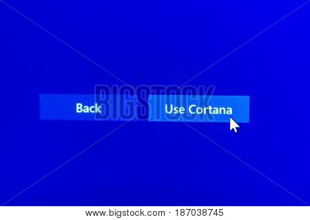 PARIS FRANCE - JAN 7 2016: Mouse arrow above USE CORTANA button on computer display during Microsoft Windows operating system installation