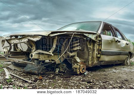 Old abandoned broken car at background of dramatic car