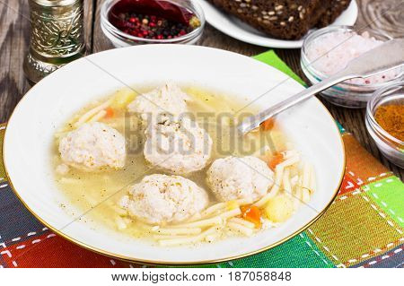 Soup with meatballs in plate. Studio Photo