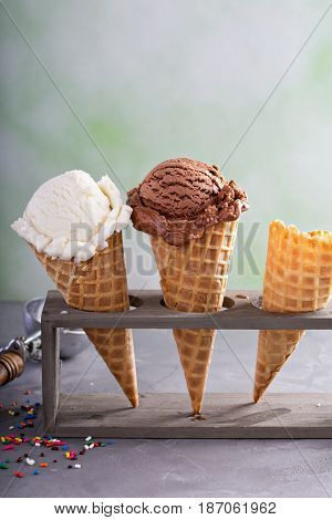 Variety of ice cream scoops in cones with chocolate and vanilla