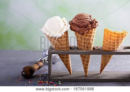 Variety of ice cream scoops in cones with chocolate and vanilla