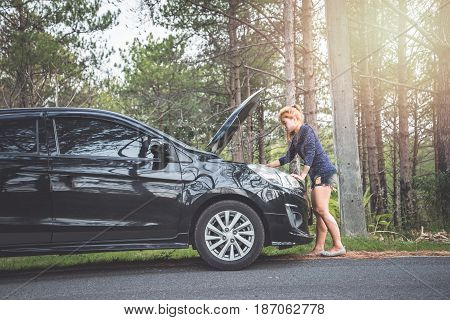 Women The car was broken on the highway. countryside
