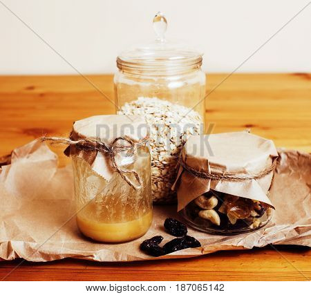 real comfort wooden kitchen with breakfast ingredients close up in glass, honey, oatmeal, milk, muesli, morning food