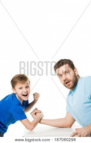 Side View Of Son With Father Arm Wrestling Isolated On White