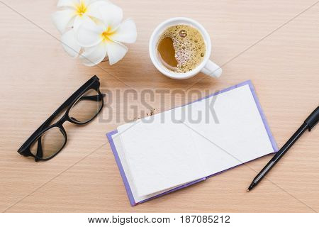 top view office with wooden table and laying on it with coffie
