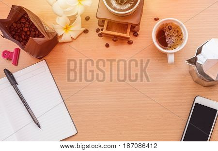 sunrise office with wooden table and laying on it with coffie