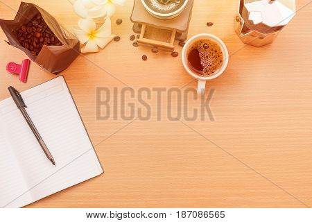 sunrise office with wooden table and laying on it with coffie