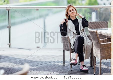 Woman Sit Near The Table Hold Her Glasses