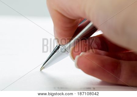 hand with fountain pen with signature