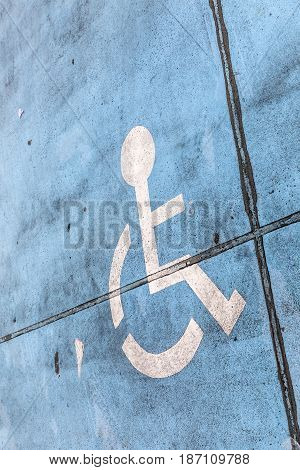 blue handicap sign at a parking lot in France