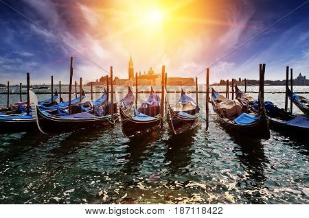 Venice. A sunset over the channel Grande and gondolas at the mooring
