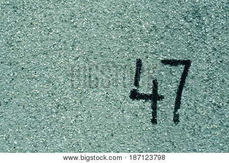 Number Fourty Seven On Cyan Plaster Wall.
