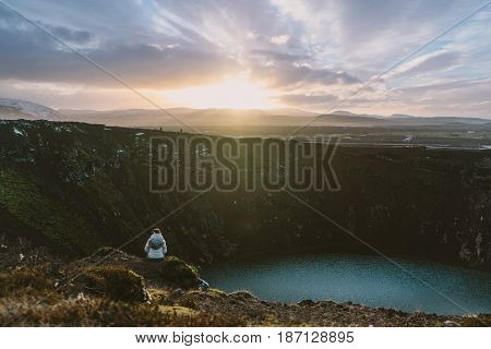 Hiking erupted Volcano Kerid in South Iceland with a beautiful sunset.