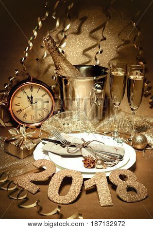 New year holiday table setting with champagne. Celebration. Place setting for new year eve. Holiday decorations. Served table