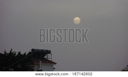 Magnificent White Sun Setting on Grey Skies