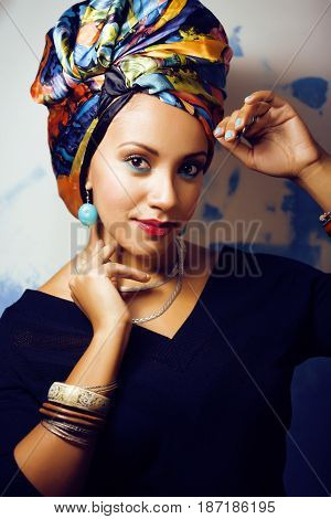 beauty bright real african woman with creative make up, shawl on head like cubian closeup smiling