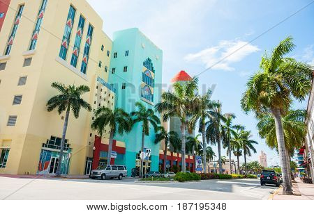 Miami, USA- June 28, 2016; Typical Miami retro styled buildings across Washington Avenue on shady side of street.