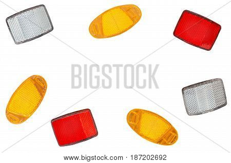 A scattering of bicycle light reflectors isolated on a white background