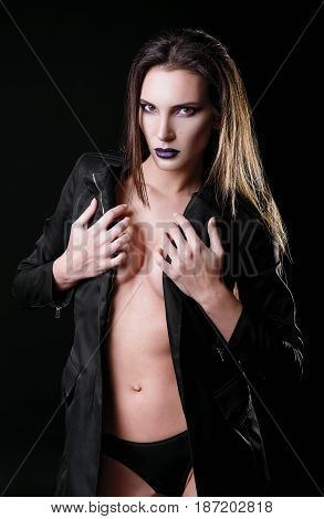Studio fashion shot: a gorgeous sexy young woman wearing black panties and jacket