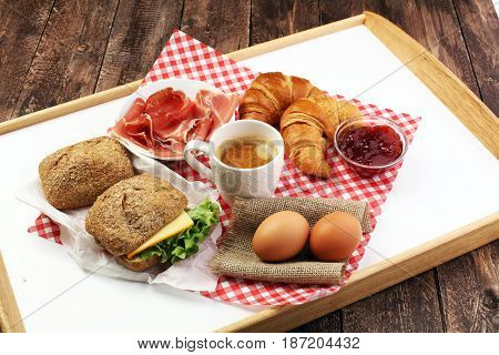 Breakfast On Table With Bread Rolls, Croissants, Coffe And Eggs