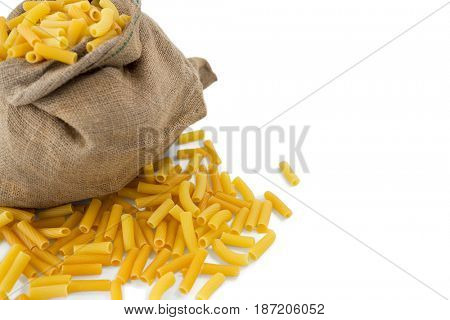 Cropped image of raw pasta in scak against white baclground