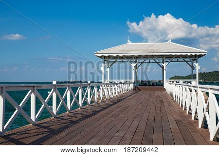 Wooden white pavilion on sunny day seacoast skyline
