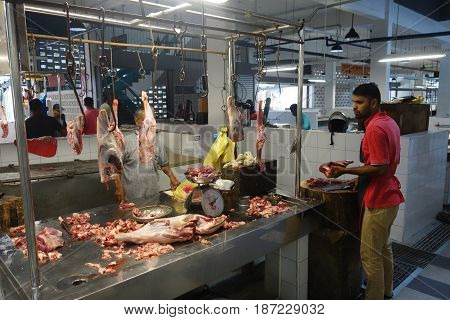 Unidentified Indian Butcher Sits At His Butcher Shop
