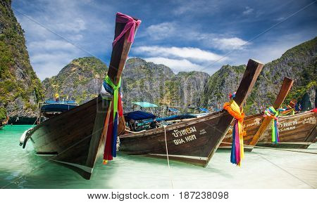 KO PHI PHI LEH, THAILAND, February 1, 2014: Traditional long tail boats on the beach of Maya Bay, Andaman Sea, famous tourist destination in the Ko Phi Phi achipelago