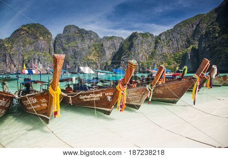 KO PHI PHI LEH, THAILAND, February 1, 2014: Traditional long tail boats on the beach of Maya Bay, Andaman Sea, famous tourist destination in the Ko Phi Phi achipelago