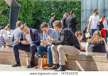 Three Businessmen On Their Lunch Break In Cabot Square, Canary Wharf