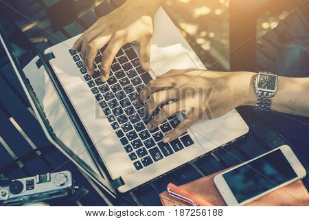 Young businessman working on laptop at garden.