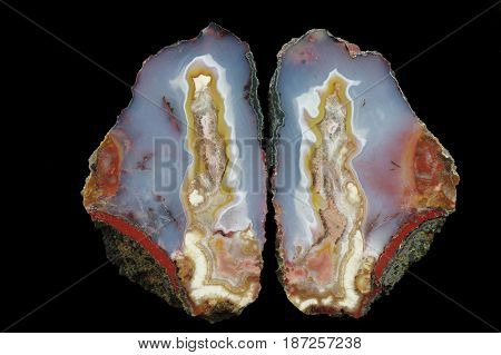 A cross section of the agate stone. A colorful center is in the blue chalice and pseudomorphs are on the shores. Multicolored silica bands colored with metal oxides are visible. Origin: Asni Atlas Mountains Morocco.