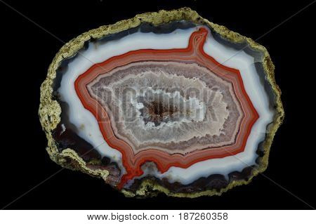 A cross section of the agate stone with quartz geode. Multicolored silica rings colored with metal oxides are visible. Origin: Asni Atlas Mountains Morocco.