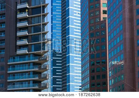 Architecture background of modern buildings standing close to each other. Urban development and urbanization concept