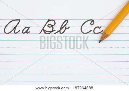 Learning to write cursive lettering Samples of cursive lettering on lined paper with a pencil