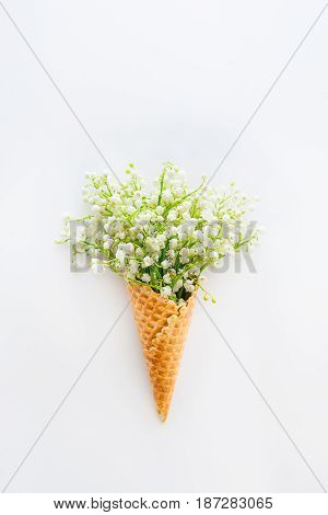 Beautiful Bouquet Of Lilies Of The Valley,may-lily Flowers In A Waffle Corn On The White Background,