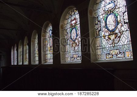Italy Florence - December 24 2016: the view of the stained glass with scenes from the life of Saint Benedict in the colloquium corridor inside Florence Charterhouse church. Certosa di Galluzzo di Firenze on December 24 2016 in Florence Tuscany Italy.