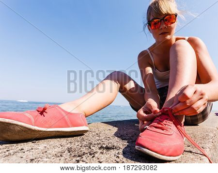 Young Girl Tying Shoelace.